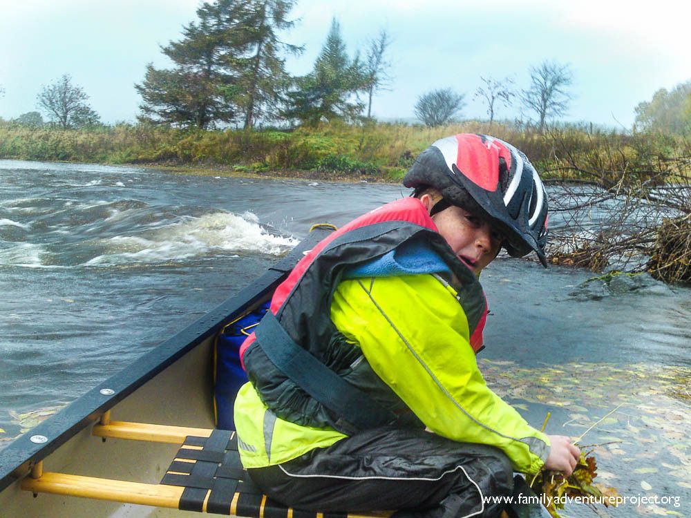 Canoeing on a river rapid