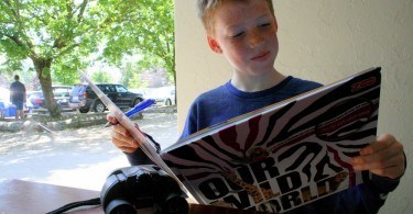 Cameron reading his guide, Givskud Zoo, Denmark