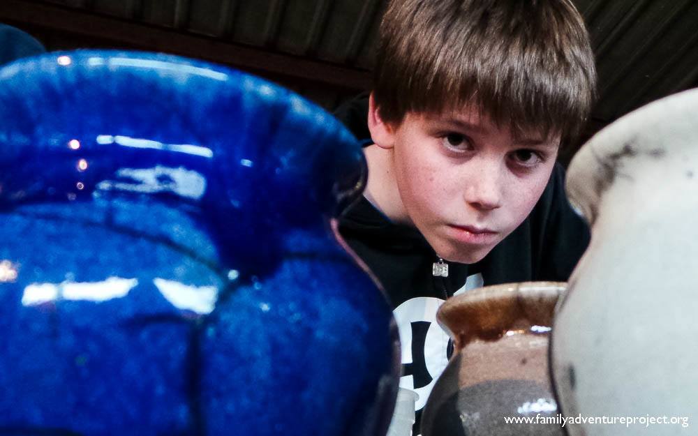 Boy between pots