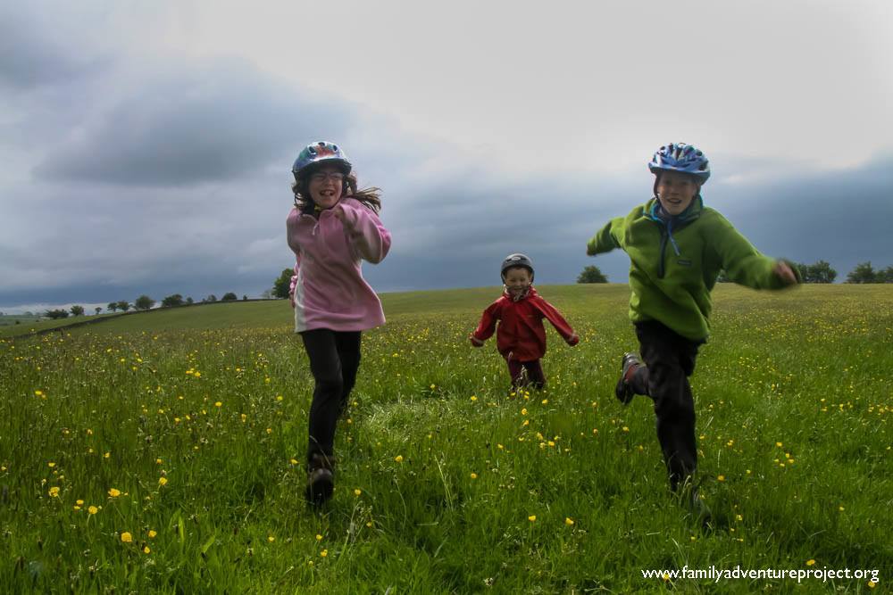 Kids running through buttercups Kids running through buttercups