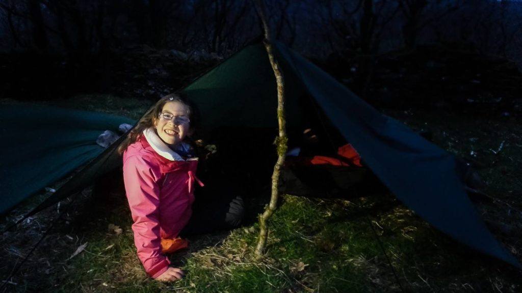 Adventure kids preparing to sleep out under the tarp Adventure kids preparing to sleep out under the tarp
