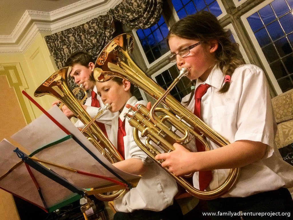 Children playing carols for old folks