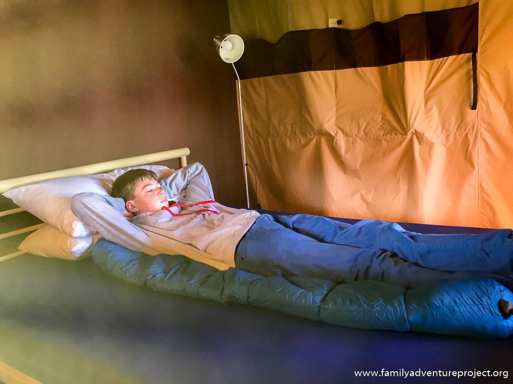 Relaxing on the bed in ReadyCamp Safari Tent