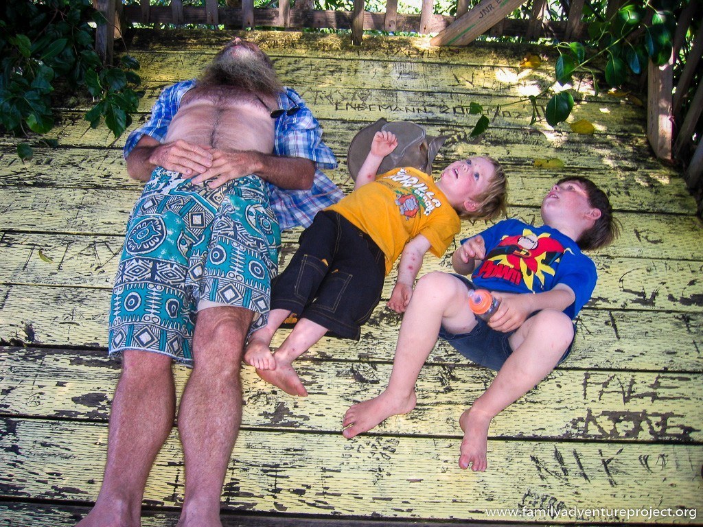 Kids staring up at the treetops in Samoan tree house