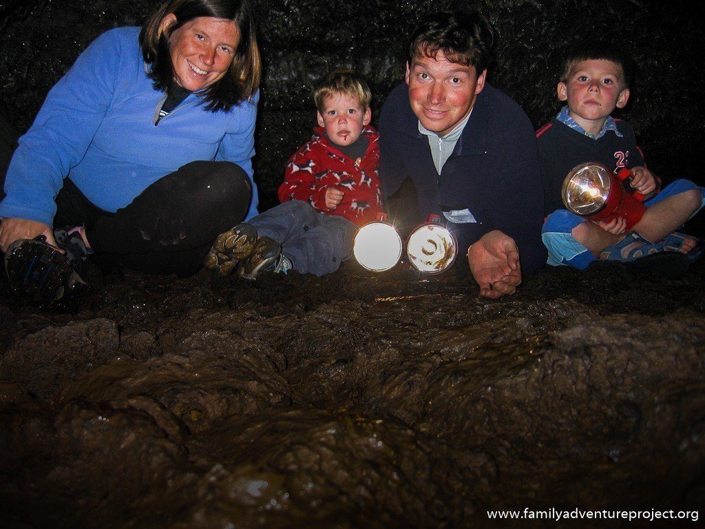 Family in a lava tube at Newbury National Volcanic Monument