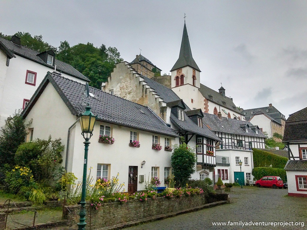 Views up to the church and Burg Blankenheim from amongst the traditional village architecture in Blankenheim town near the source of the Ahr